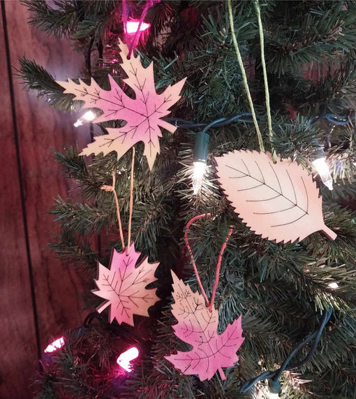 Hand colored wood leaf shape ornaments Autumn colors of read orange yellow and green