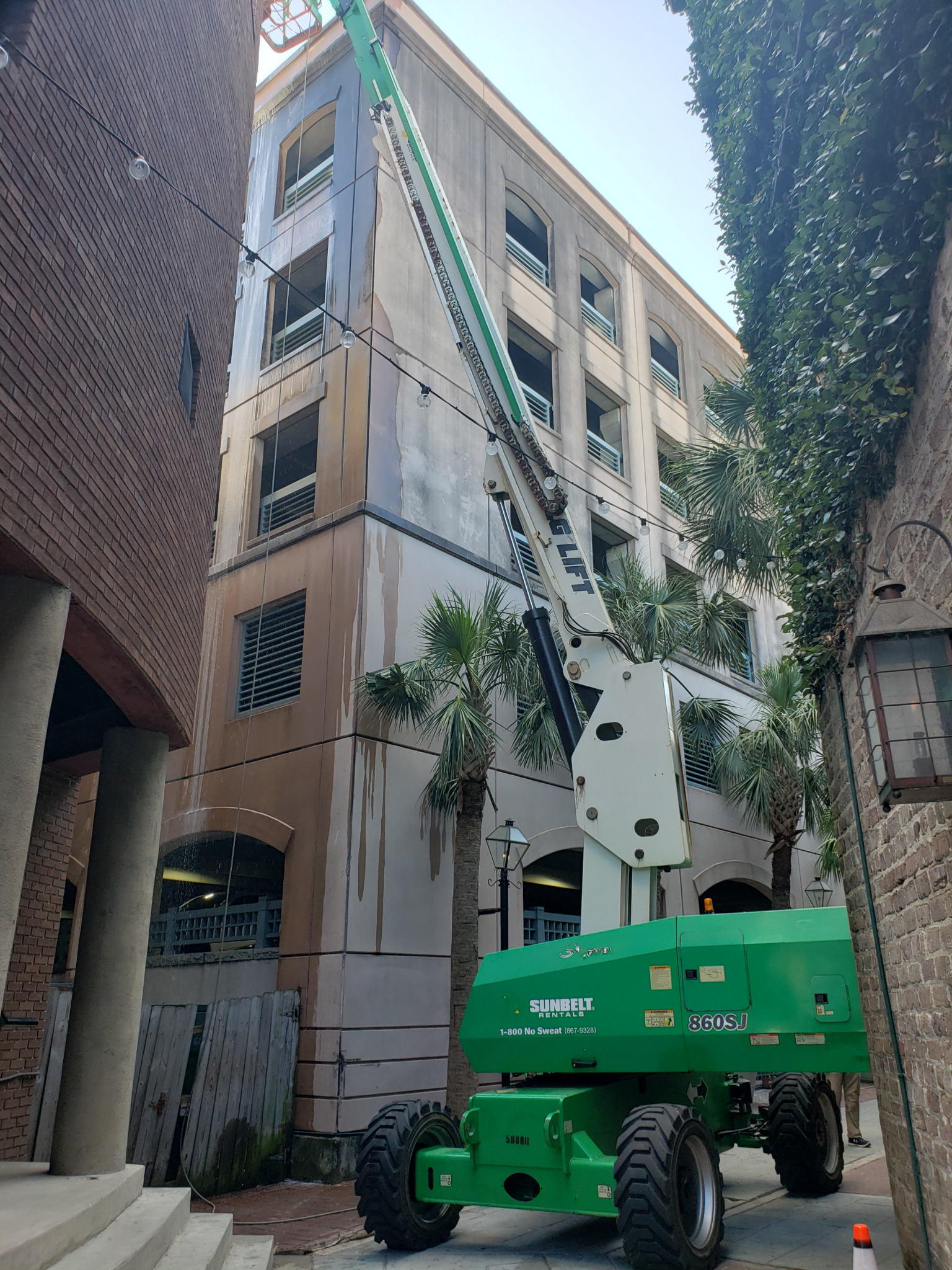 Boom lift in position for elevated exterior specialty cleaning