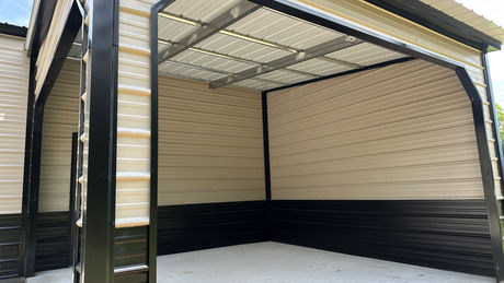 Metal carport structure, black and tan exterior, open space with concrete flooring, STORMSAFE STEEL.