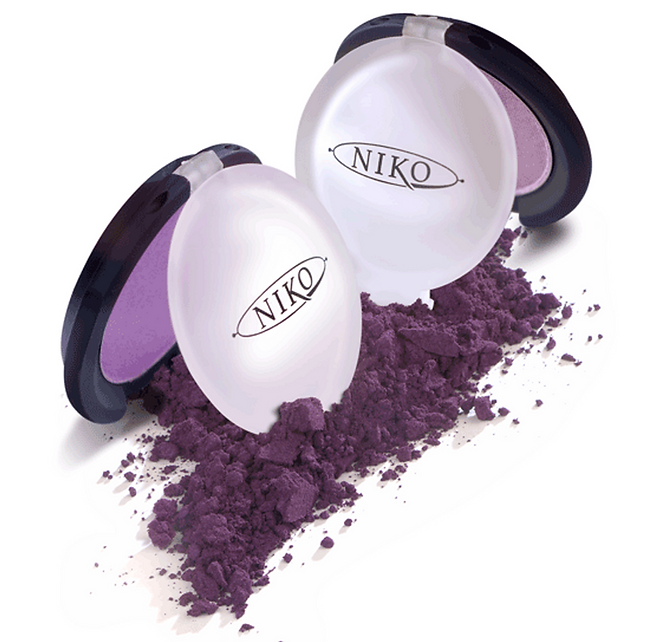 image of 2 NIKO Eye Shadow clamshell style compacts, half open, propped over powder