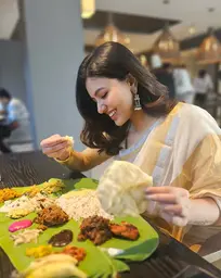 Anju Kurian in special tissue saree having Kerala Sadhya during a festive occasion