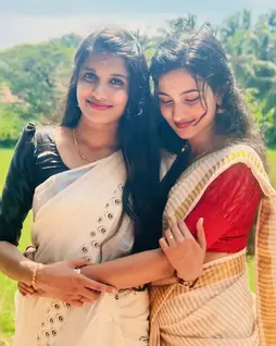 Vidya in Peacock Designer Kerala Silver Kasavu Cotton Saree hugging Hari Priya in Tissue Stripe Kuthampully Saree, sharing love and joy