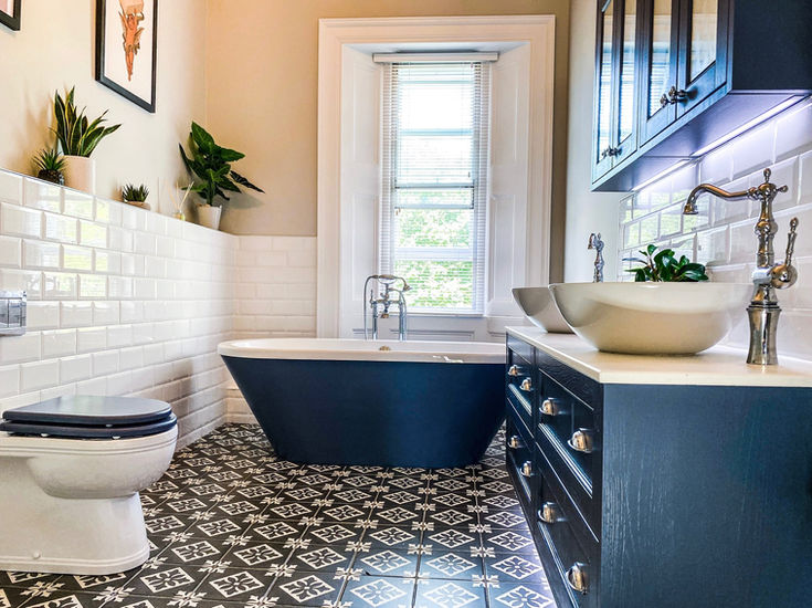 large traditional family bathroom in blue with white subway tiles
