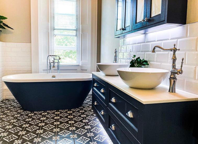 double vanity unit in family bathroom with blue bathtub