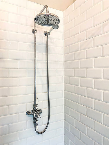 hansgrohe shower kit in silver with white subway wall tiles