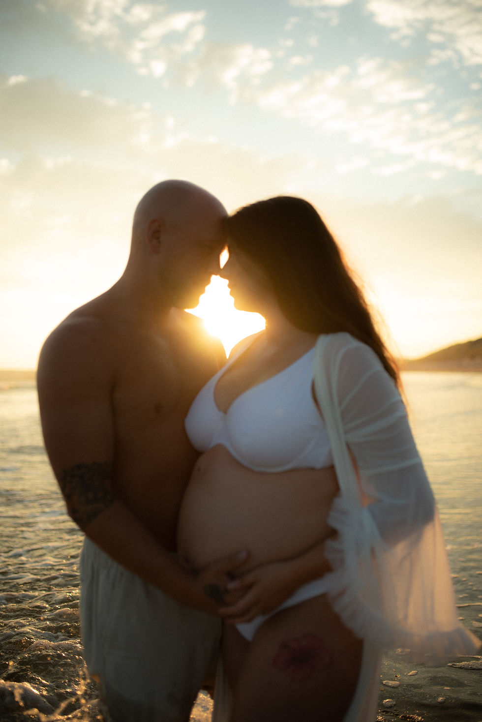 A couple on the beach at sunset