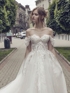 Signature off-the-shoulder ballgown on a tree-lined street