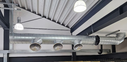 Independent fresh air system sprial duct with white circular diffusers.