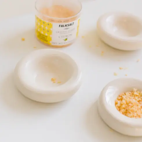 three handmade ceramic donut bowls in white filled with artisan salt