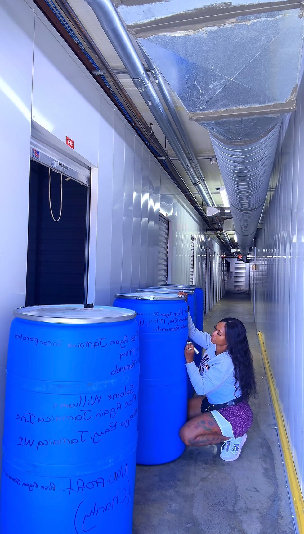 Eye-level view of a large shipping barrel filled with essential supplies for families in Jamaica