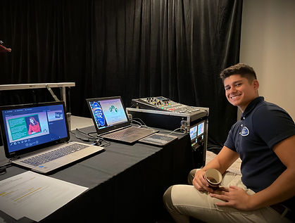 AV operator smiling behind a tech table