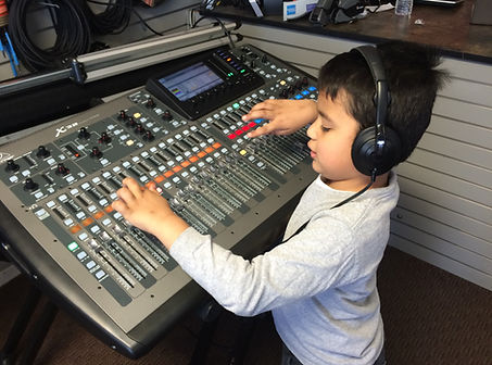 Live sound engineer operating a digital mixer