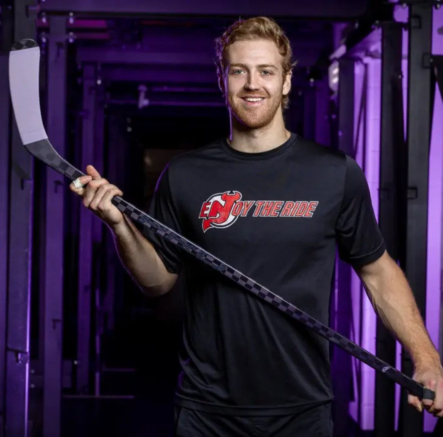 Dougie posing with Thea's hockey stick