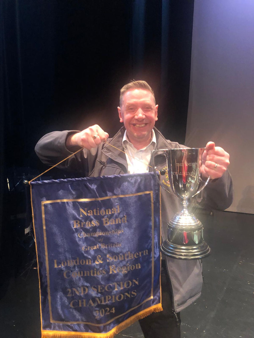 Euph and contest secretary Leighton with the winning tropy, best conductor tropy and 2nd section champions banner