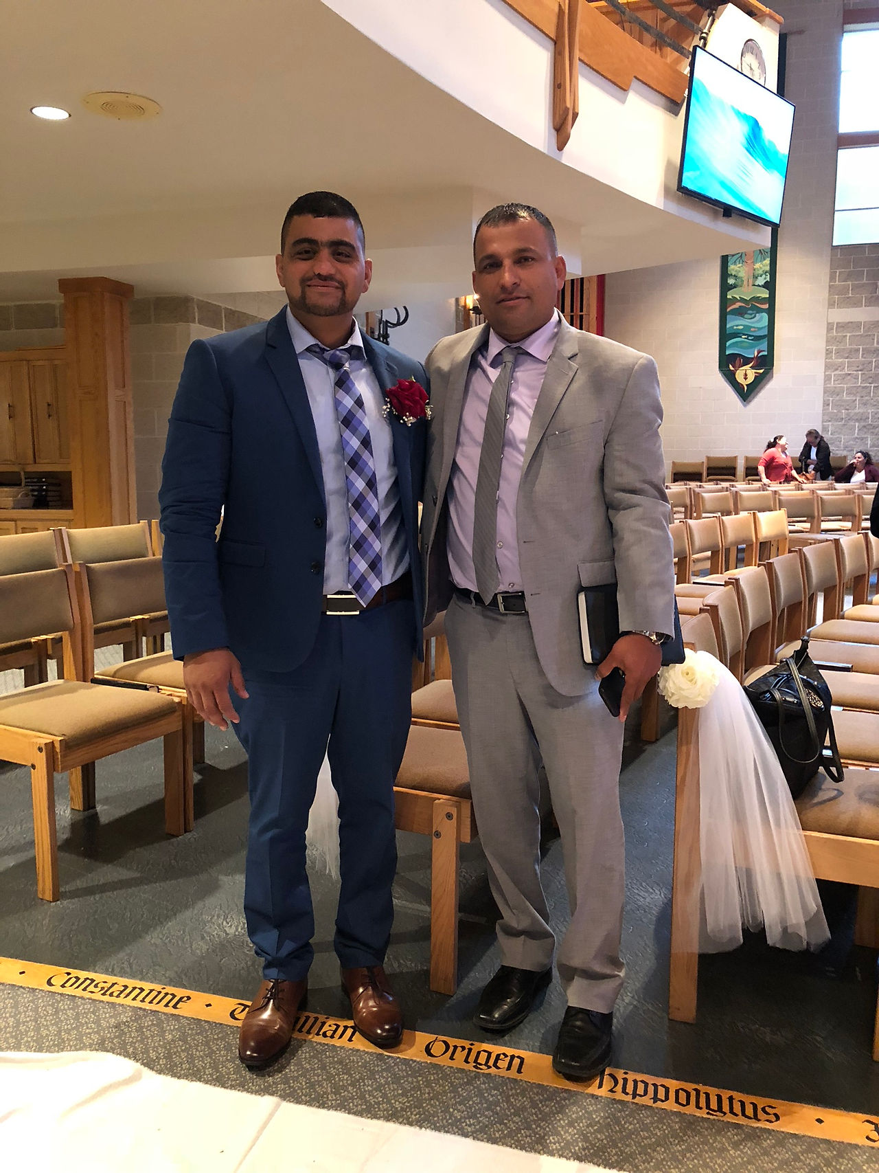 Leo dressed formally, standing next to a friend.