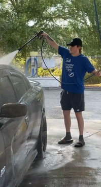 Sam cleans his Dodge Charger Scat Pack.