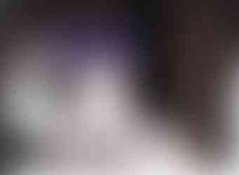 Zach wears a big purple hat as a baby.