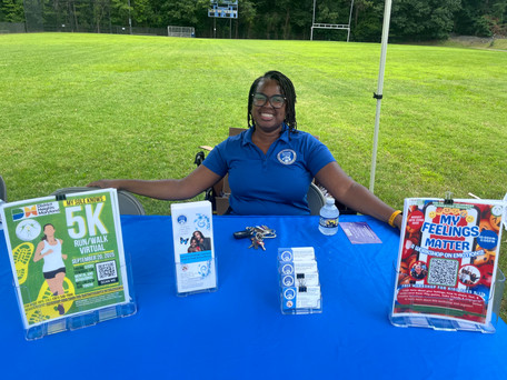 A representative from District Heights Maryland sharing resources at Infinite Legacy's Block Party.