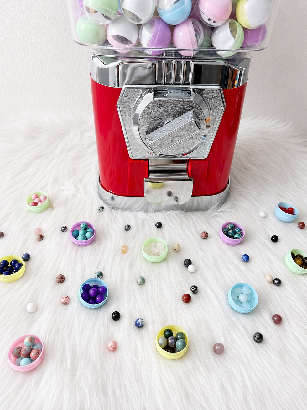 Assorted 8mm gemstone beads displayed beside the mystery capsule machine