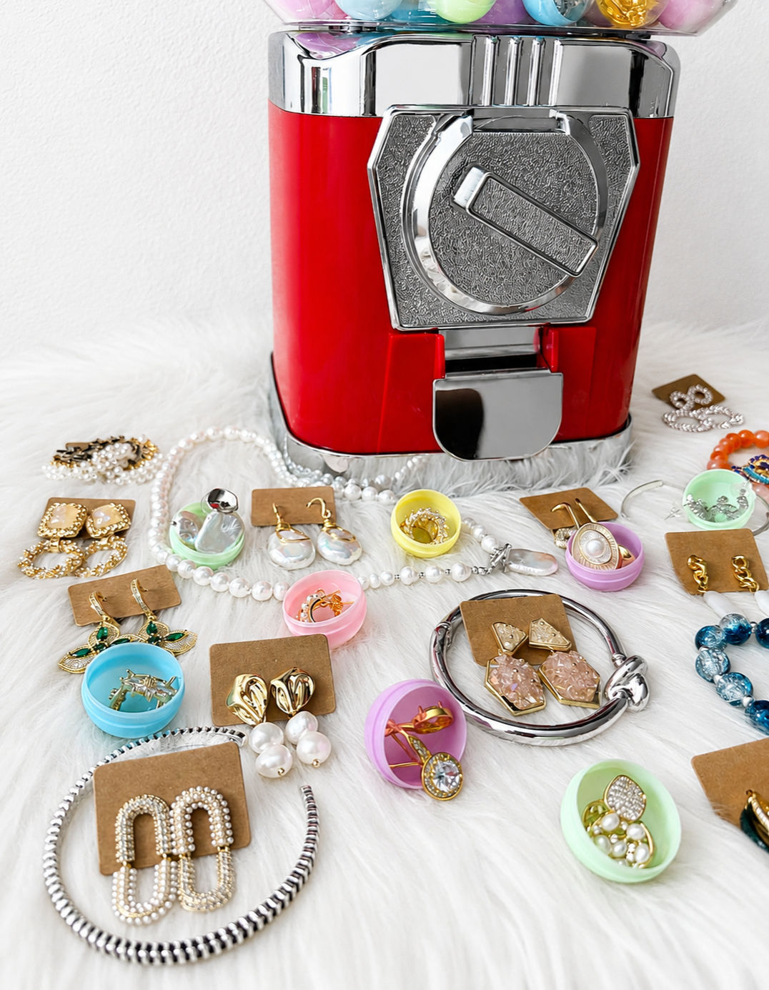 Red mystery capsule machine filled with pastel capsules for the Jewelry Mystery Draw