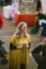 My happy face talking with customers and vendors at one of my 2023 markets at the Port (coffee in hand, of course).