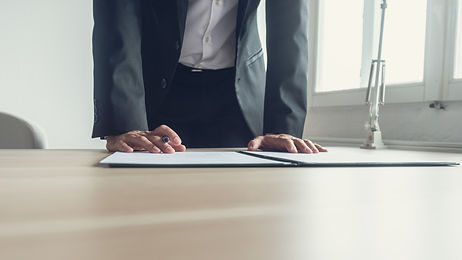 businessman-standing-his-office-desk-leaning-sign-legal-document-contract-with-fountain-pe