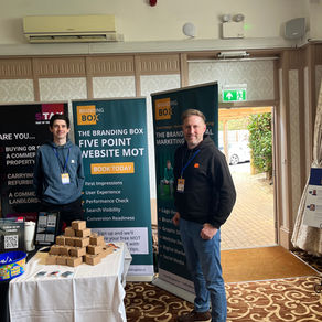 Nick and Richard at their stand with roller banners in the background.