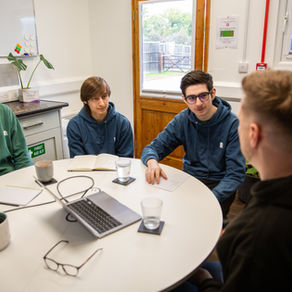 The Branding Box Team having a discussion at their meeting table.