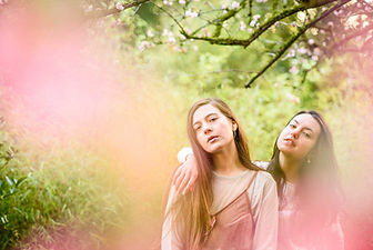 fashion nature wildlife photography portrait Two girls surrounded by blossoms