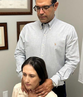 Dr. Gabriel Guerrero checking thyroid