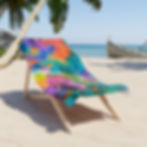 Colorful abstract beach towel on a wooden chair; blue ocean background.