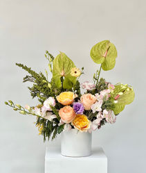 Blush and ivory garden-style centerpiece for wellness or retreat event