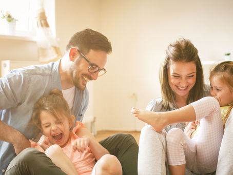 Parents playing with children, representing the importance of choosing a guardian.