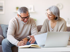 Husband and wife reviewing estate planning documents together to prepare for the future.