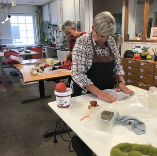 Two people are felting