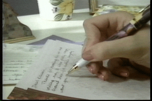 a hand writing with a pen