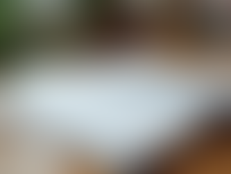 Eye-level view of a middle school math workbook open on a wooden table