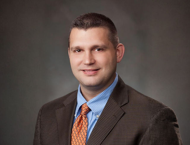Patrick Aliff in a professional suit.