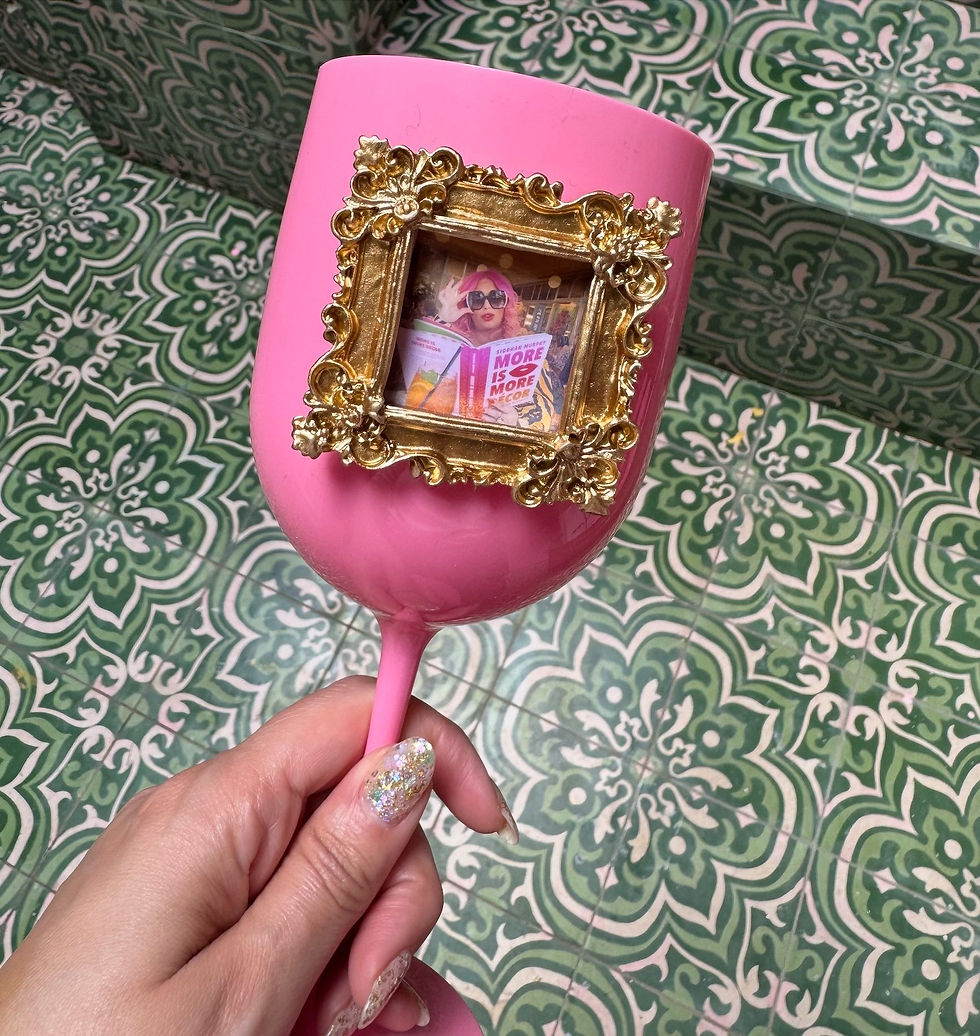 Personalised pink wine glass with miniature gold baroque frame against green zellige tiles at Starseed House Marrakech — gift for Interiorcurve