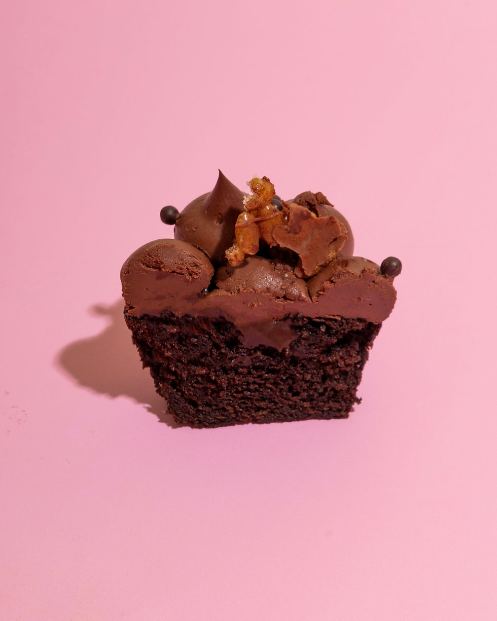 Thumbnail: Chocolate cupcake with chocolate frosting on pink background
