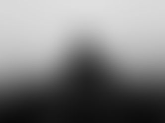 A person's silhouette merges with foggy train tracks, creating a haunting, monochrome scene with a somber, reflective mood.