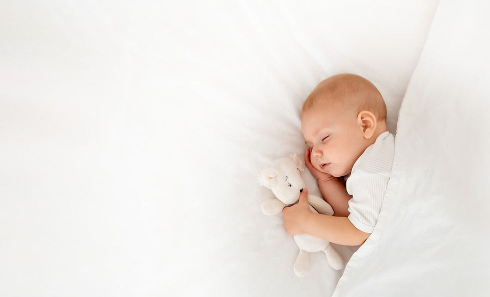 Baby sleeping with a teddy