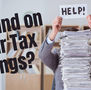 Taxpayer behind on tax filings, surrounded by stacks of paperwork, seeking help with overdue tax returns and IRS compliance.