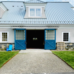 Blue barn doors with stone pathway