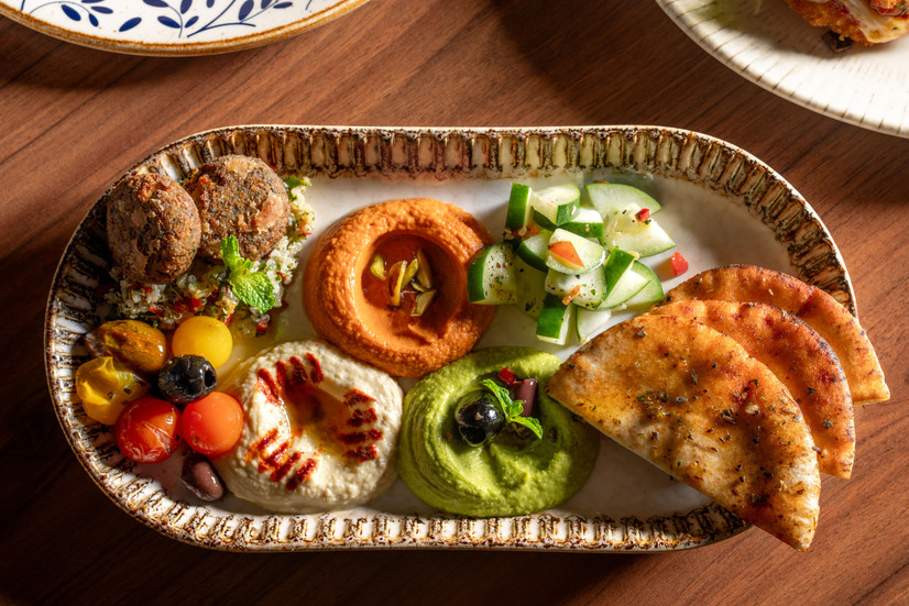 Fetaccine hummus trio with pita, vegetables, olives and Mediterranean-style appetizers from Carnival’s new dining update