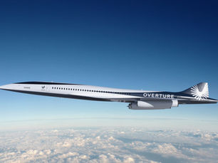 Boom Supersonic Overture commercial airliner flying above clouds with sleek white and navy blue livery, representing the future of supersonic passenger aviation
