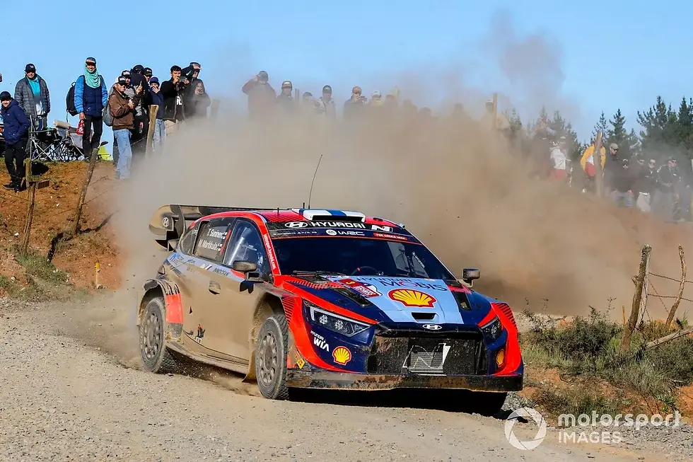 A crowd of spectators watch Suninen hunting Tanak down