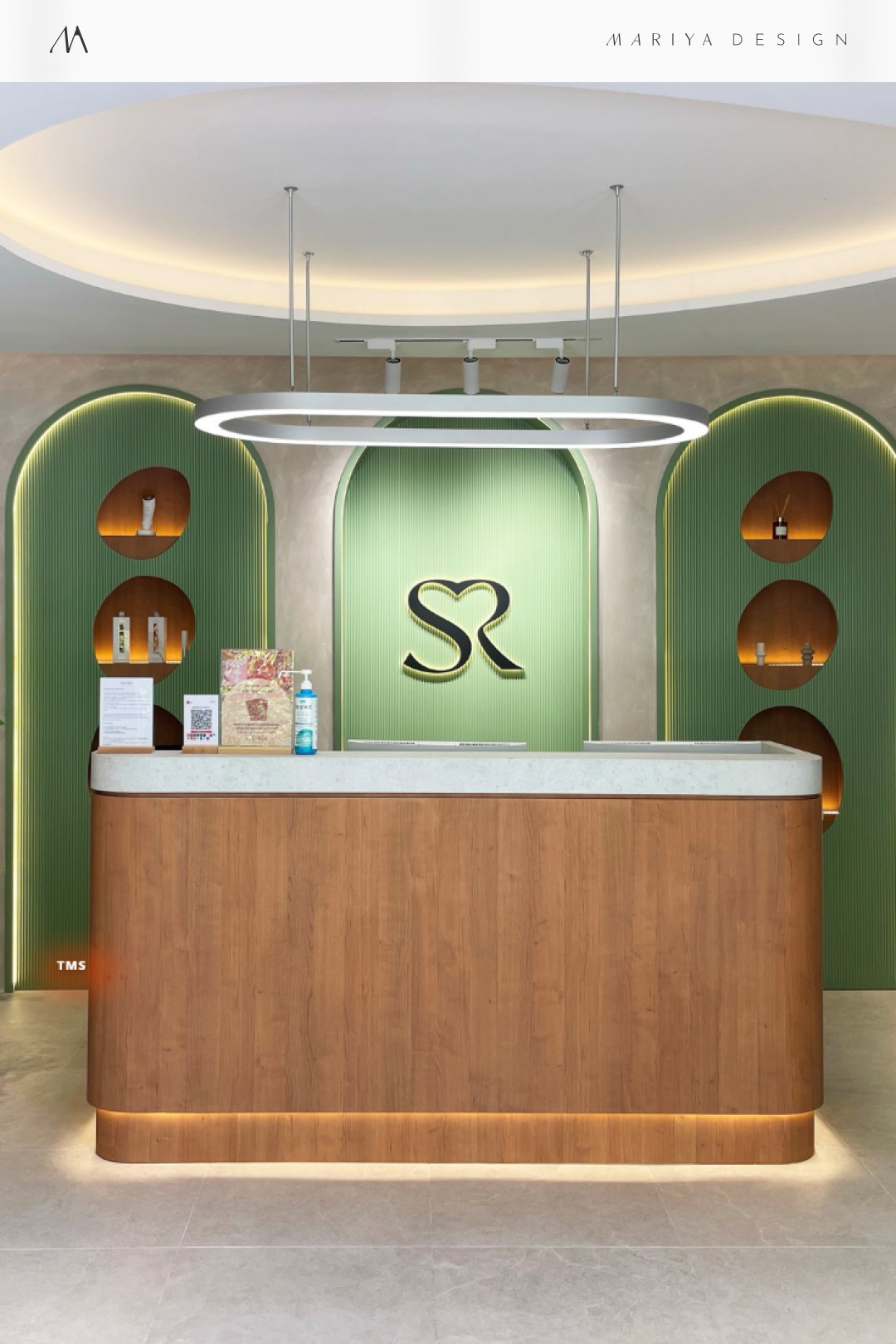 Beauty lounge / Reception — The monogram and brand colors in a completed location.