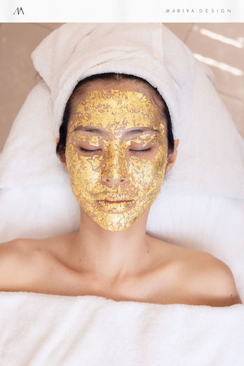 SAE-REN gold facial treatment photography showing a client with a metallic gold mask in a luxury spa setting.