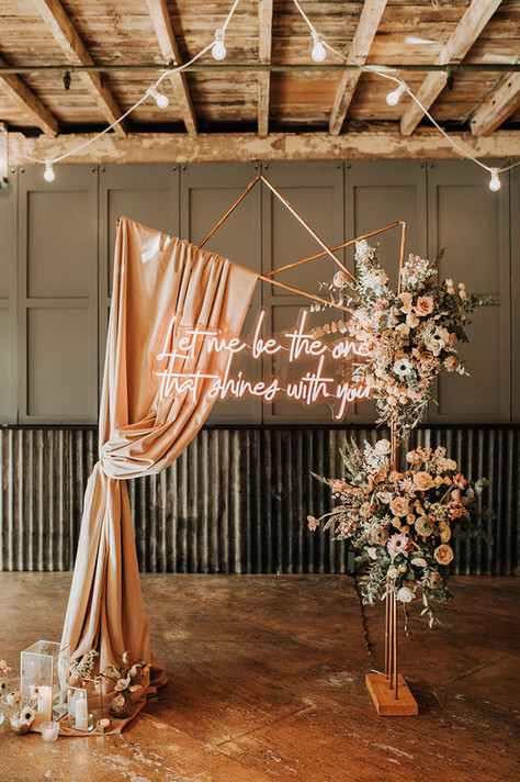 Copper Arch Wedding with Velvet Fabric Drapes and Neon Sign